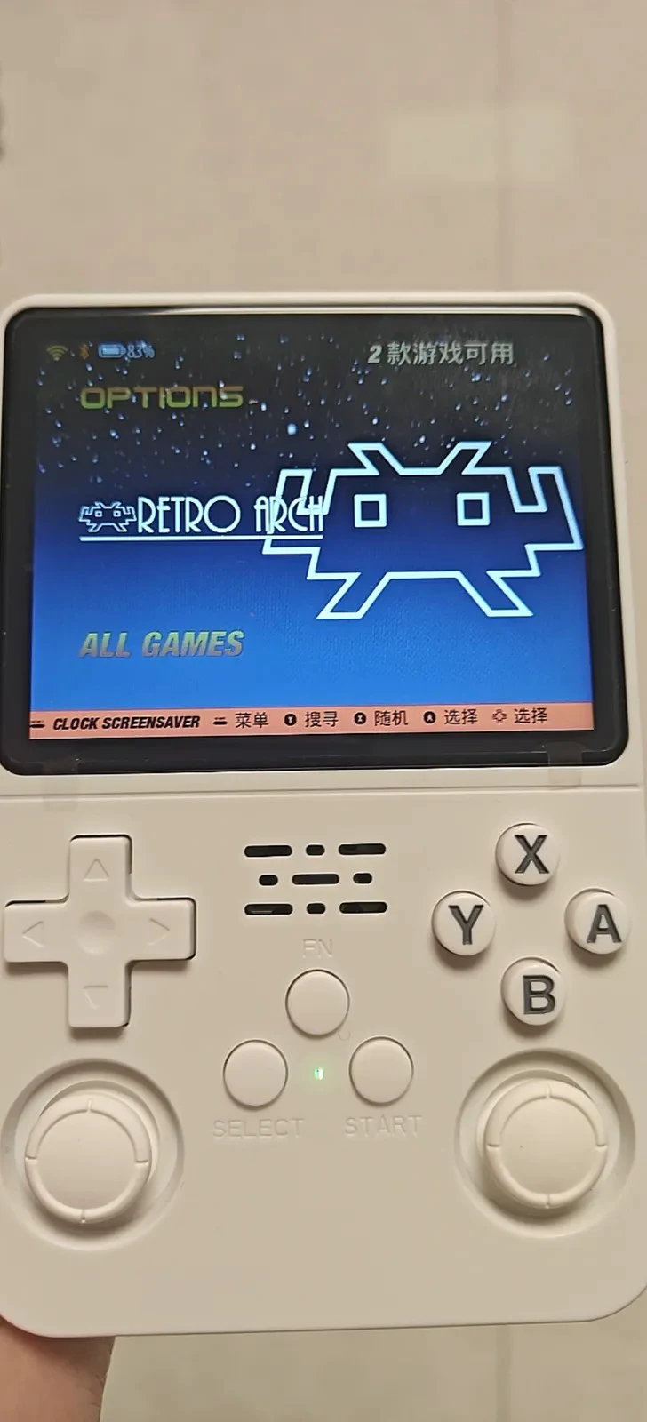 A white R36S on the vendor stock front-end with a green indicator and a status bar battery icon reading 83 percent